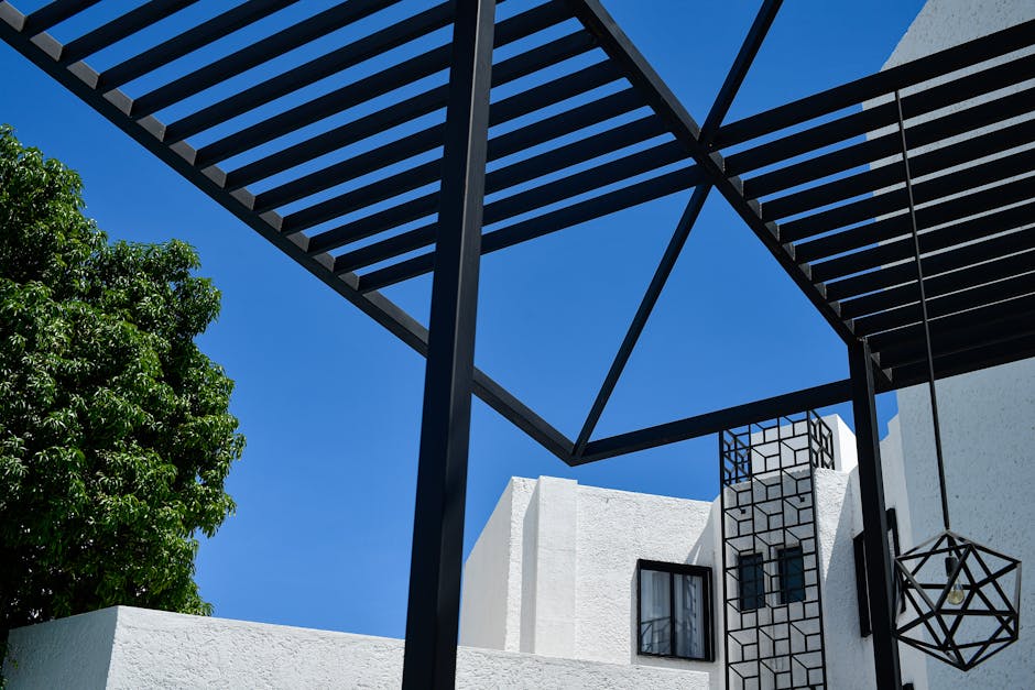 Contemporary architectural design in Cancun, featuring geometric structures contrasted against a clear blue sky.
