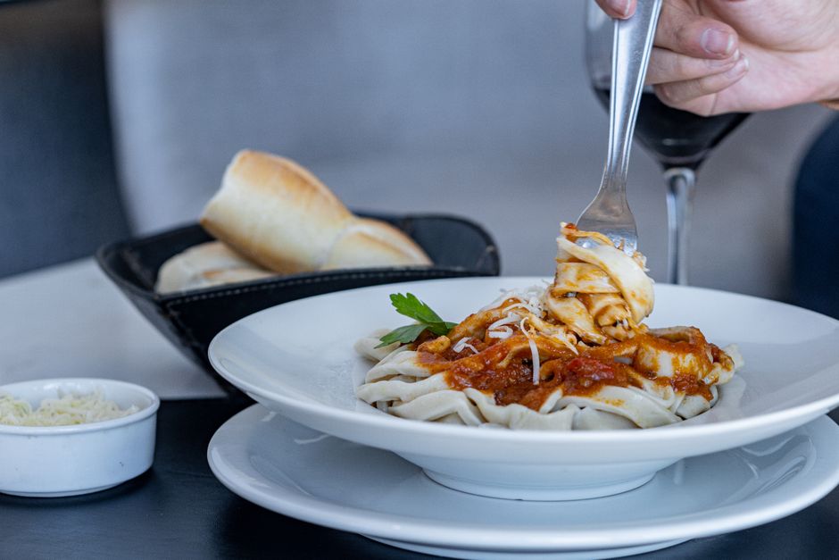 Close-up of tagliatelle pasta with tomato sauce and parmesan, perfect for food photography.