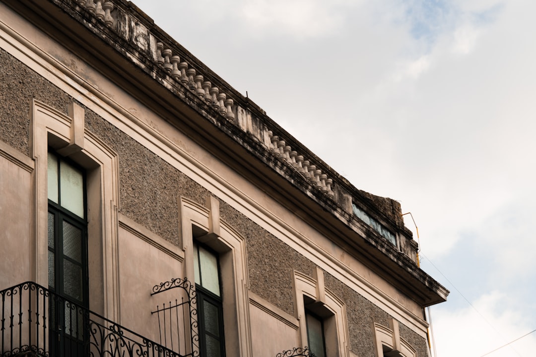 a building with a balcony and wrought iron balconies
