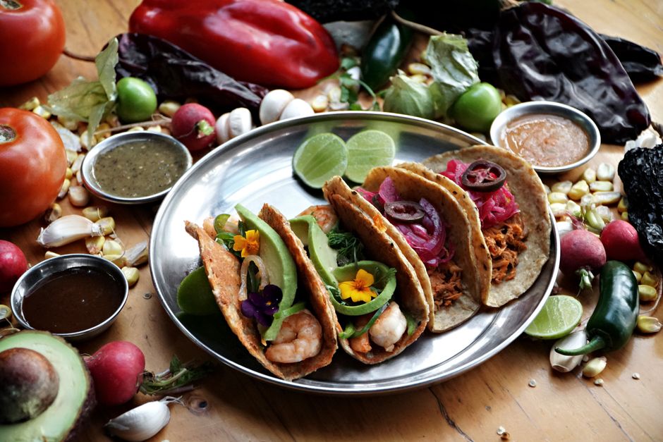 A vibrant array of Mexican tacos served with fresh ingredients, perfect for culinary delight.
