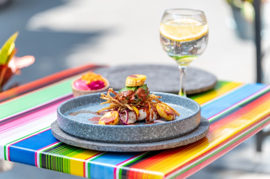 Colorful Mexican gourmet dish served outdoors in CDMX with a refreshing cocktail.