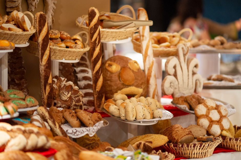 A colorful assortment of artisanal breads and pastries displayed in a bakery setting.